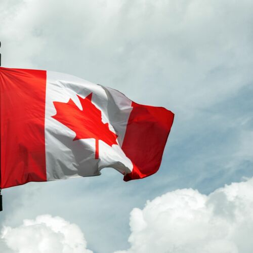 Flag of Canada on flagpole floating in the sky